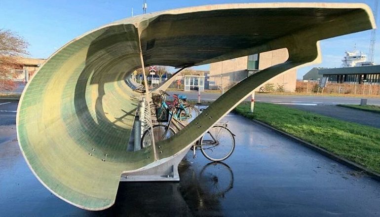 This decommissioned Siemens Gamesa wind turbine blade has been repurposed as a bicycle parking shed in Denmark 