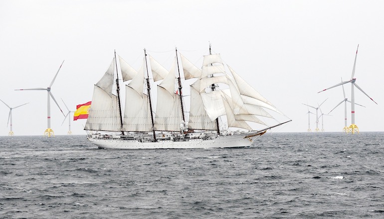 The Royal Spanish Navy training ship Juan Sebastián de Elcano sails past Iberdrola's 350MW Wikinger offshore wind farm