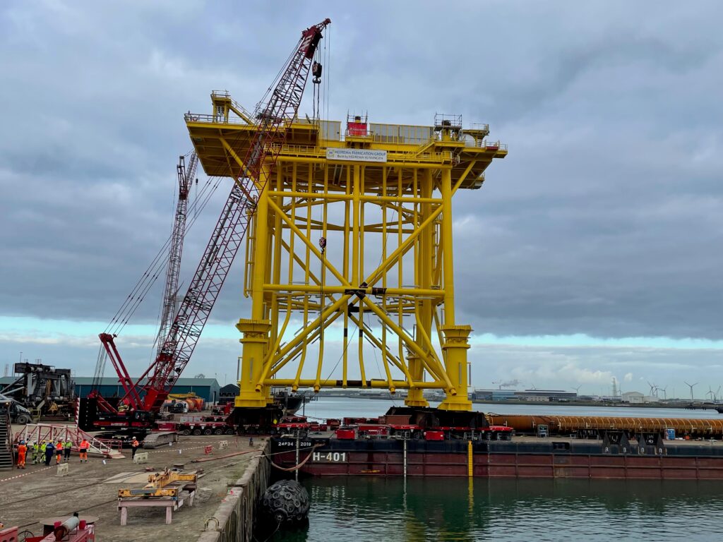 The load-out of the jacket for TenneT’s offshore platform Hollandse Kust (north) has been successfully completed in the Port of Vlissingen after the construction of about 2,100 metric tonnes was safely brought onboard a pontoon from the yard of Heerema Fabrication Group by load-out specialist Mammoet The load-out of the jacket for TenneT's offshore platform Hollandse Kust (north) has been successfully completed in the Port of Vlissingen after the construction of about 2